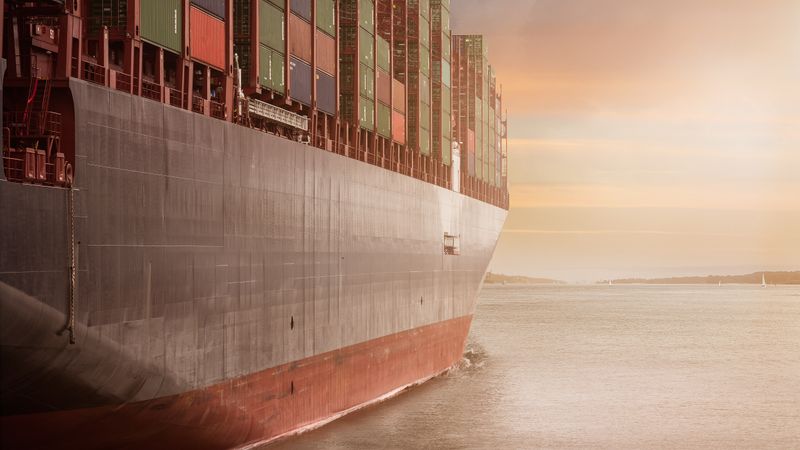 Container ship loaded with cargo at sea