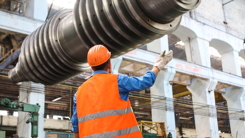 Engineer inspecting heavy machinery during technical maintenance